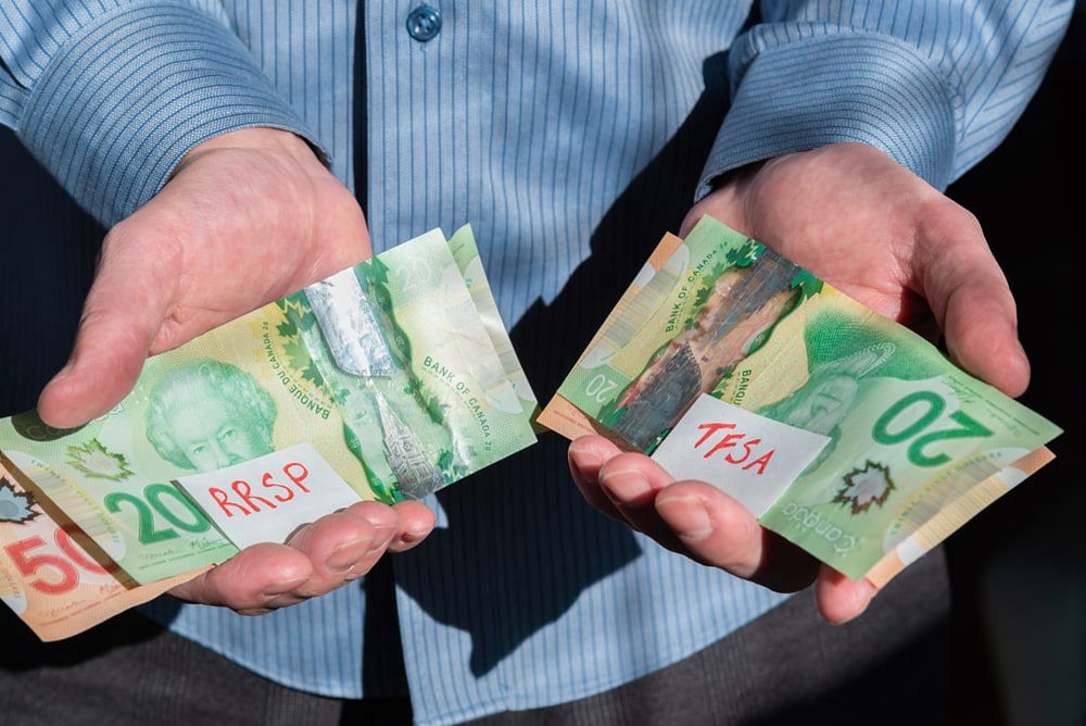 Close-up of man's hands holding Canadian cash for RRSP and TFSA investments