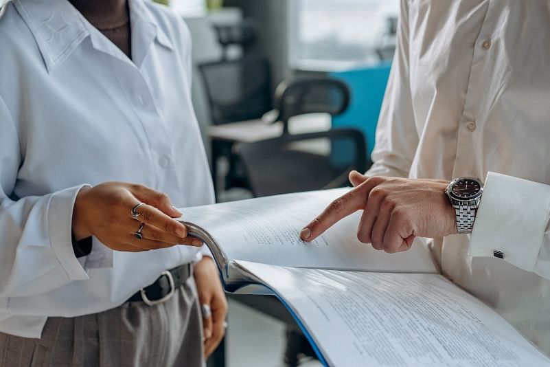 closeup shot of two people looking and discussing a business report