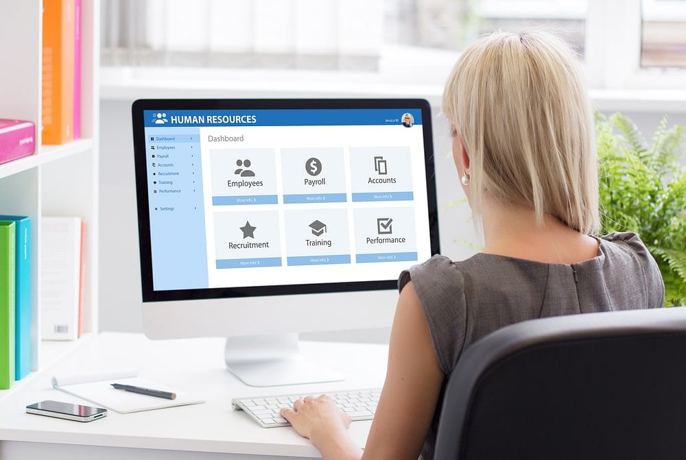 shot of a human resource personnel using payroll management system software on their computer